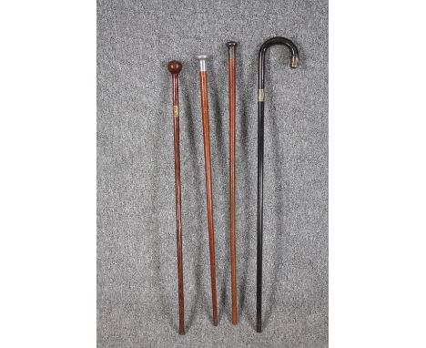 A collection of four walking canes. The darker stick with  a silver collar and end. L.92cm. (longest) 