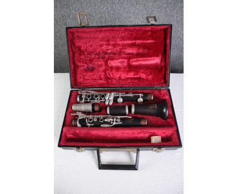 A Boosey and Hawkes clarinet. Complete and in its  original felt lined case. L.35 W.23 cm. 