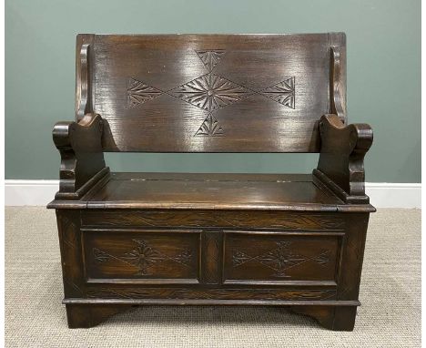 VINTAGE OAK MONKS BENCH with carved detail to the top and the lower panels, scroll effect arms and hinged lid box seat, on co