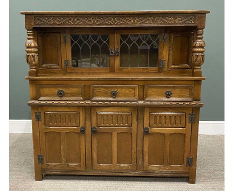REPRODUCTION OAK CARVED BUFFET SIDEBOARD, having leaded glass upper doors below a carved front frieze and flanked by bulbous 