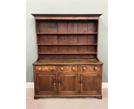 GEORGE IV NORTH WALES OAK DRESSER having a wide border three-shelf rack on a peg joined construction base, the three plank to