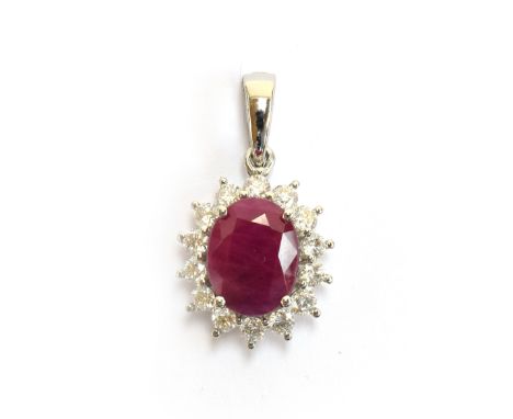 A platinum mounted ruby and diamond cluster pendant, the Burmese ruby 3.25cts and 10x8mm, diamonds totalling 0.83cts, 1.5cm l