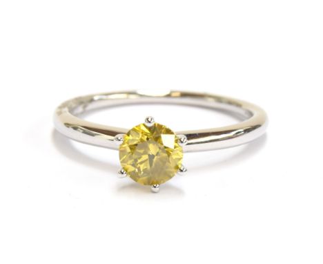 A platinum mounted yellow canary diamond solitaire ring, the diamond weighing 1ct, size R 1/2, 4.6g 