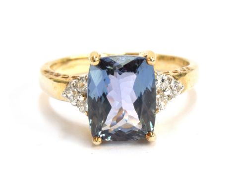 A 9ct gold, chameleon tanzanite and white zircon ring, the fancy chameleon tanzanite 3.3cts and 10x8mm, the white natural zir
