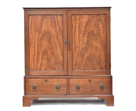 A George III mahogany dwarf linen press, the panelled doors opening to four slides, over two drawers, on bracket feet, 125cm 