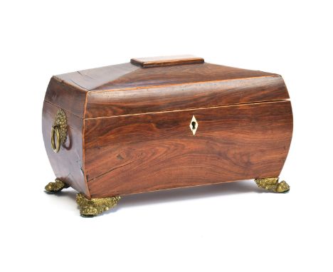 A Regency mahogany and line inlaid sarcophagus tea caddy, tablet top, with twin brass handles, opening to a fitted interior w