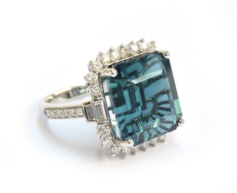 An 18ct white gold, blue tourmaline and diamond cluster ring, the Monte Belo indicolite tourmaline 16.5cts and measuring 15x1
