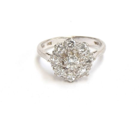 An 18ct white gold diamond cluster ring, total diamond carat approx. 1.5cts, size N 1/2, hallmarked for London 1975, 4.9g