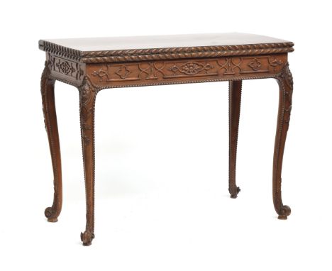 An 18th century mahogany card table, the foldover top with gadrooned edge, over a blind fretwork frieze, the cabriole legs wi