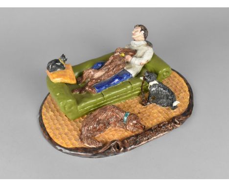 A Studio Pottery Figure Group, 'Stress Cure', Modelled with Man and His Dogs Relaxing on Sofa, 27cm wide 