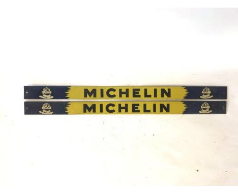 A pair of Michelin tin shelf strips.