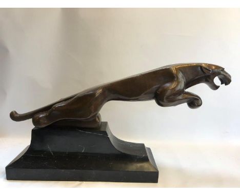A bronze leaping jaguar showroom advertising centrepiece on a stepped marble base.
