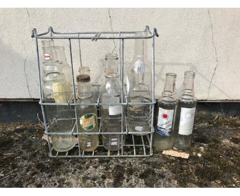 An eight bottle oil crate marked Property of Esso, with ten assorted glass oil bottles, some with labels. 