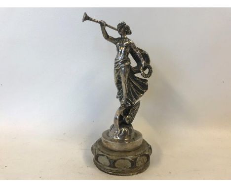 A rare Austin Motor Company radiator mascot in the form of an elegantly dressed lady blowing a horn stood on a winged wheel, 