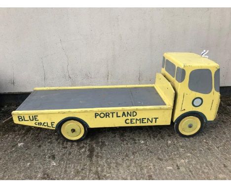 A decorative wooden model of a Portland Cement flatbed truck. 