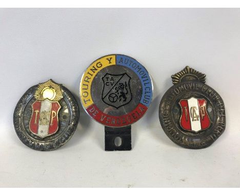 Two Touring Automobile Club of Peru badges, and a Touring Automobile Club of Venezuela badge. 