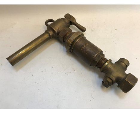 A bronze petrol nozzle. 