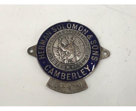An enamel dealership supply plate for Herman Soloman and Sons of Camberley, with central St. Christopher badge. 
