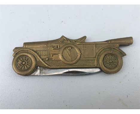A small penknife in the form of a vintage car. 