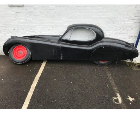 A large rare fibreglass full-size model of a Jaguar XK120 in side profile, as an advertising piece for the wall of a showroom