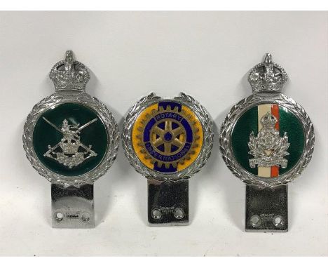 A group of three vintage car badges by Gaunt including Rotary International. 