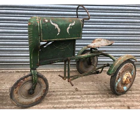 A tinplate pedal car in the form of a three wheeled tractor, possibly a John Deere.