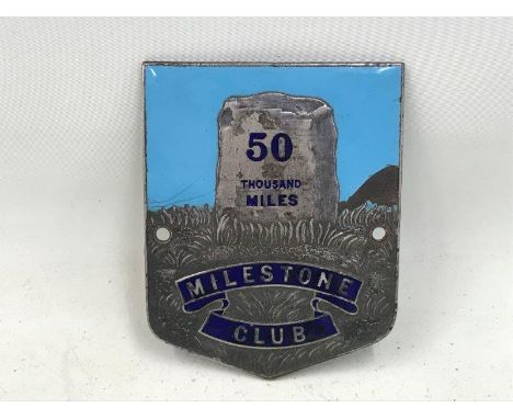 A Milestone Club '50,000 miles' part enamel car badge.