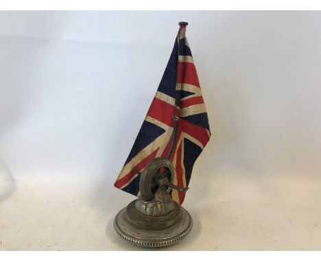 A very unusual, early and rare Austin car mascot in the form of a wheel and a flag pole with Union Jack flag, mounted on a ra