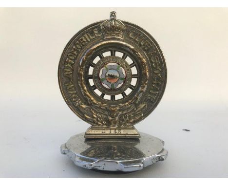 A Royal Automobile Club associate car badge with North Yorkshire Automobile Club enamel centre stamped B145, the enamel centr