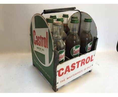 A Castrol Motor Oil nine bottle crate with enamel signs all around and nine Castrol bottles, some full. 