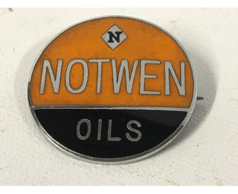 A Notwen Oils circular enamel badge. 