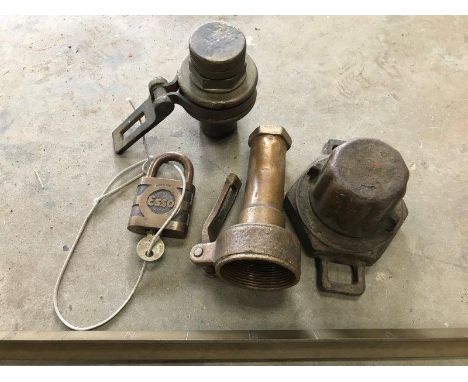 An Esso tanker padlock and key, a brass dipstick and three lockable tank caps. 
