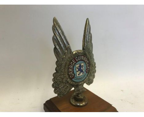 An unusual Continental badge with enamel centre, to one side marked: Garage Guinard and CIE Compiegne and to verso: a part en