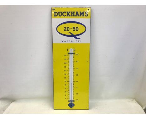A Duckham's 20-50 Motor Oil enamel thermometer in very good condition, 13 x 36".