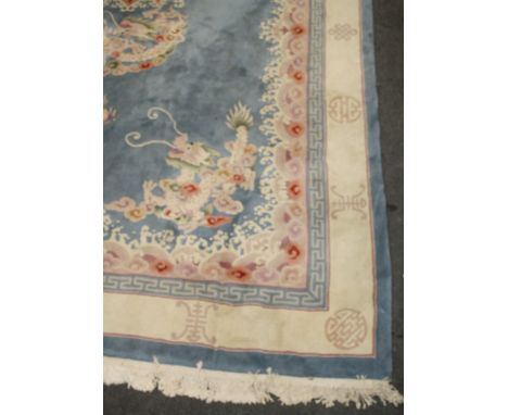 A contemporary Chinese sculpted and super washed carpet, with blue ground, pearl and dragon motif and wave borders, 375 x 278