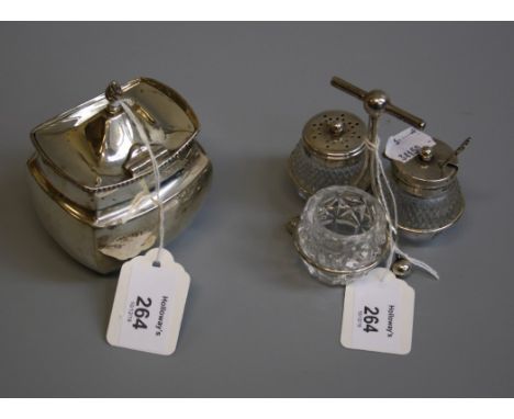 An Edwardian silver three bottle and cut glass cruet stand, in the Christopher Dresser-style, Sheffield 1903, by Asman of She