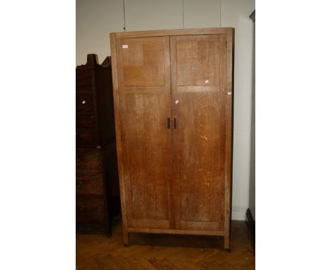 A Heals of Tottenham Court Road limed oak two door compactum wardrobe