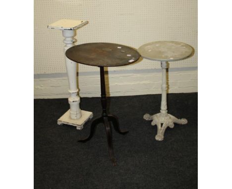 A George III mahogany oval top pillar table, together with a cast iron circular wooden top table and a painted torchere