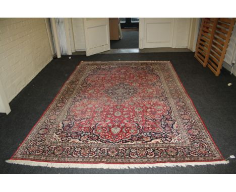 A red ground Kashan carpet with scrolling Islimi decoration, 310 x 210cm