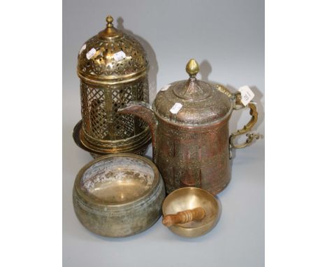 An Islamic pierced brass 'Thousand-eye' hanging lantern and two singing bowls and an Eastern copper vessel