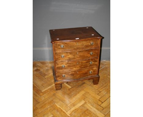 A serpentine fronted George III chest commode, now fitted as a cellarette, 63cm wide 