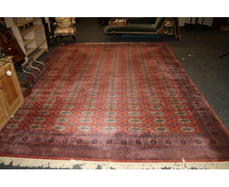 A large machine woven Tekke style carpet of red ground, 299 x 420cm