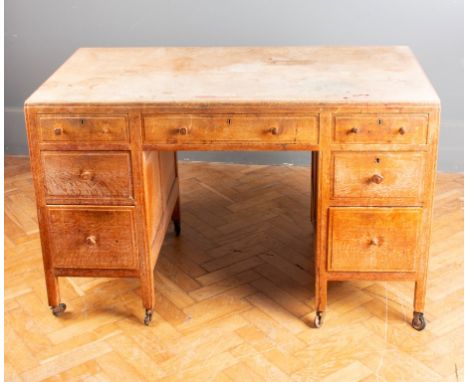 A Heals of Tottenham Court Road style light oak kneehole writing desk with moulded caddy top, 121cm wide