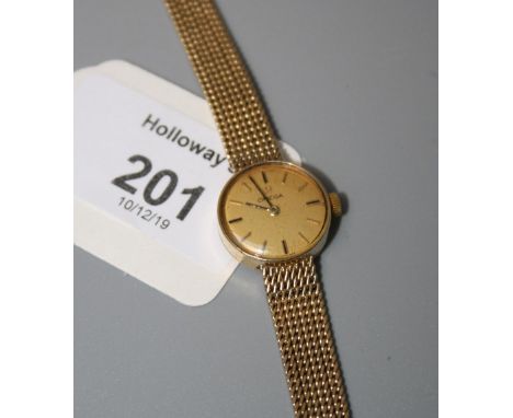 Omega, a lady's 9ct gold Omega wristwatch, circular champagne dial, baton numerals, and integral 9ct gold mesh link bracelet,