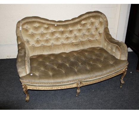 A Victorian carved wood and gilt gesso button back upholstered two seat sofa, 130cm wide