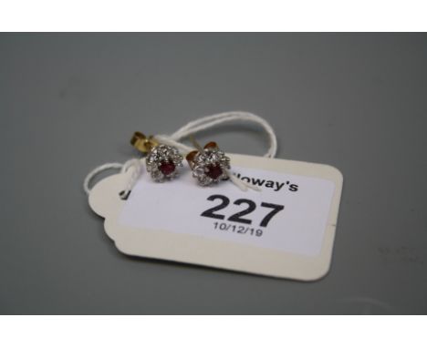 A pair of ruby and diamond circular cluster earrings, in 18ct gold mounts