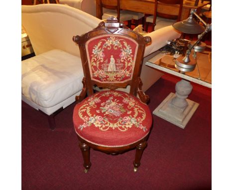 A Victorian inlaid mahogany side chair upholstered in needlepoint tapestry fabric and raised on turned supports 