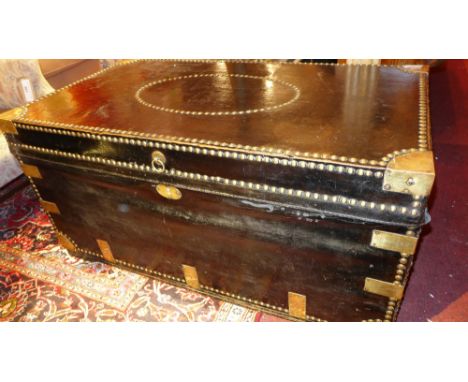 A 19th century black leather travel trunk with brass fittings, studded detail and twin handles 