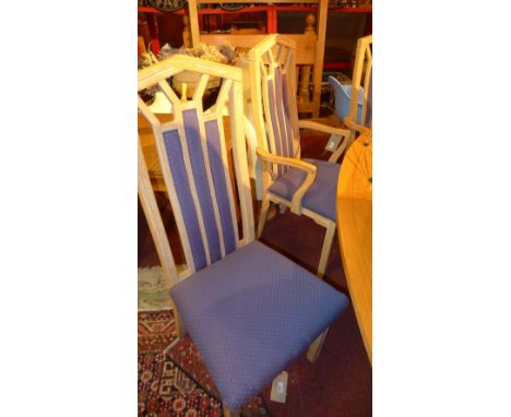 A set of ten light oak dining chairs with upholstered seats raised on square section supports  