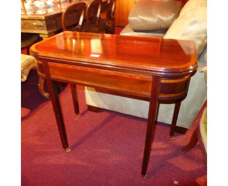 A Georgian style mahogany card table the foldover top raised on square tapering supports 